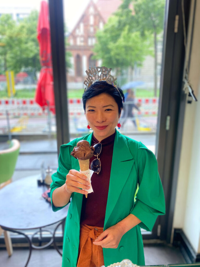 Portrait of Alex Wonder – the author smiling happily wearing a birthday tiara in Berlin.