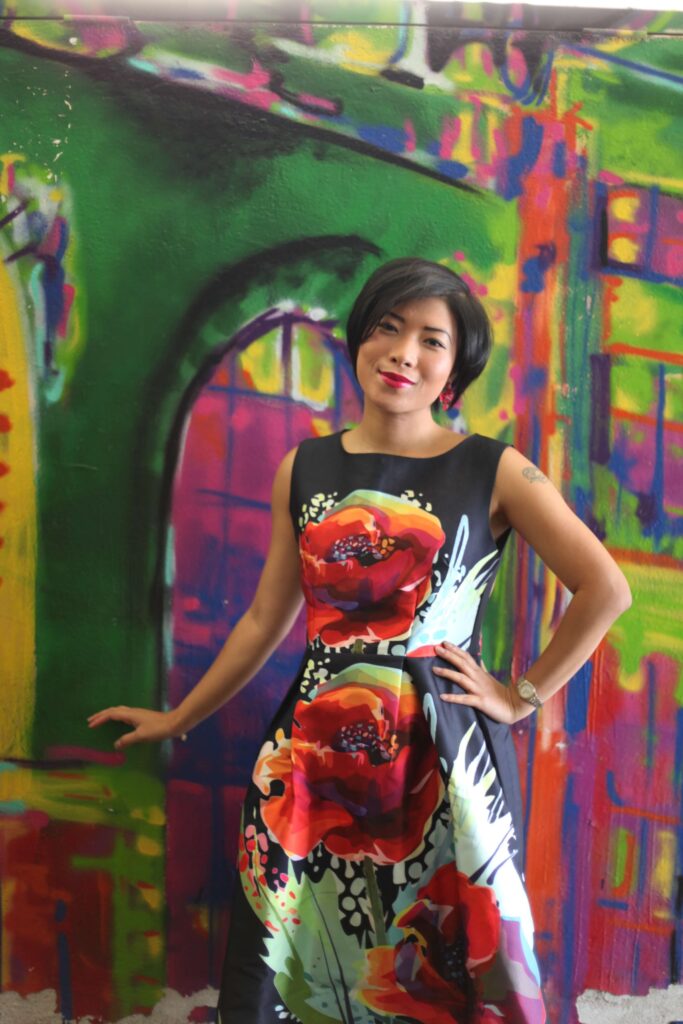 Alex standing in front of a vibrant graffiti wall in Gdańsk, Poland, symbolizing creativity, freedom, and bold expression.
