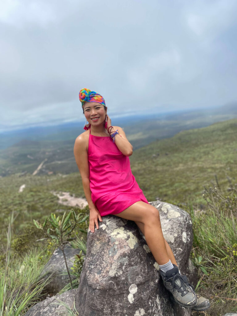Portrait of a woman surrounded by lush nature in Vale do Capão, Brazil, looking serene and connected to the landscape